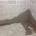 What are the elements of a basement waterproofing solution?