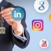 Businessperson presenting a key while social media icons float around, symbolizing social media security (LinkedIn, Instagram, YouTube, Facebook, Twitter, Google)./** concise **/